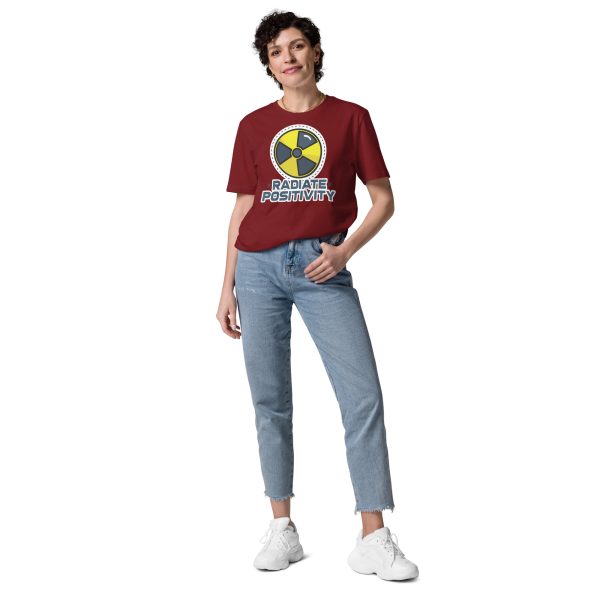 Woman posing in a trendy way with her left hand on her pocket while wearing a t-shirt with an Icon that is used to represent radioactive danger with the quote "Radiate Positivity", this is supposed to be a funny and not at all corny radiography pun.