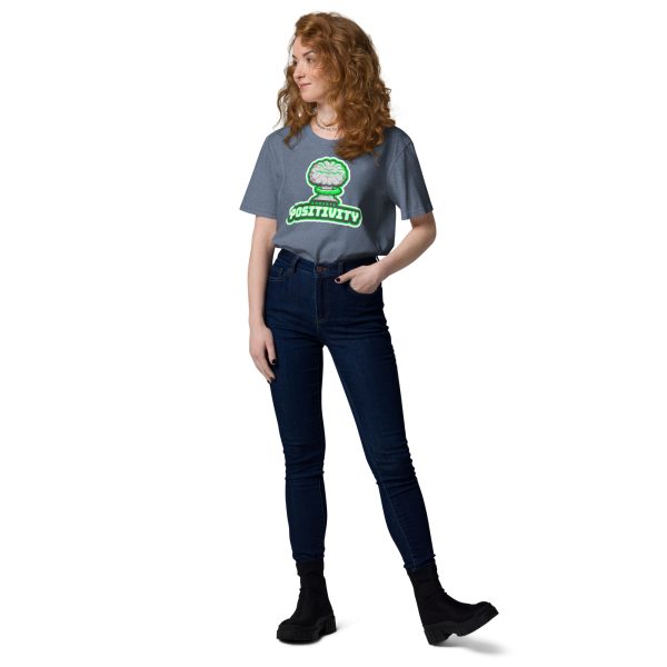 Woman looking at her right with her left hand in her pocket posing for a photo while wearing a t-shirt with the design of a nuclear bomb explosion with a green tint indicating radiation, with the quote "Radiate Positivity" below, this trying to be a radiation pun.