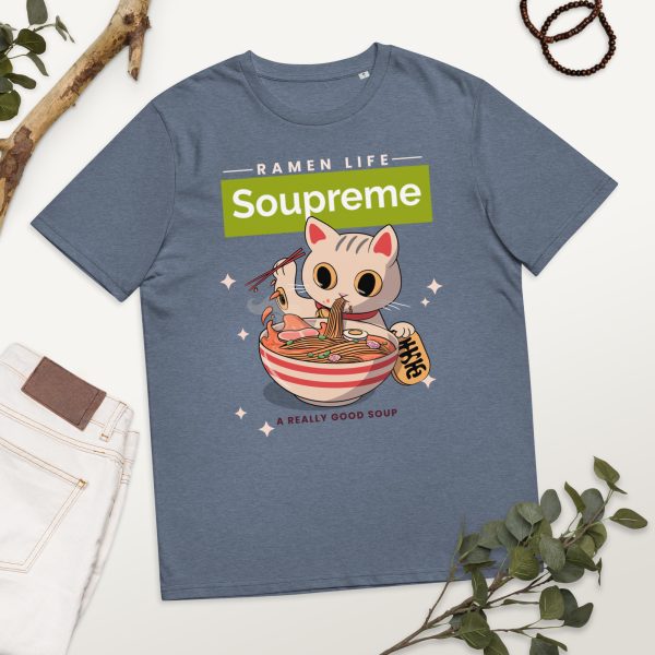 Organic cotton t-shirt in a photographic background with decorative elements, featuring a design of a japanese manga/anime cartoonish style cat eating ferociously a bowl of ramen noodle soup. Above there is a logo that reads: Soupreme; not being related to any particular brand and intended as a funny pun regarding the main subject of the design, which is ramen noodle soup.