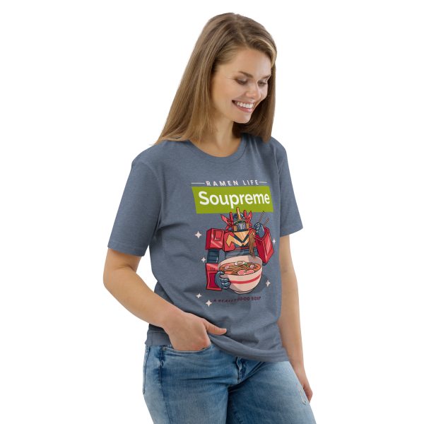 Woman smiling looking down with her body inclined to the left, right hand on her pocket. She is wearing a t-shirt featuring a japanese manga/anime styled transformers-looking robot eating a big bowl of ramen noodle soup with the logo above that reads: Soupreme; not related to any particular brand, only being there as a joke to the main subject of the design, that being ramen noodle soup