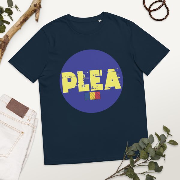 T-shirt featuring PLEA's logo in the middle of it and occupying much of the space of the t-shirt, which is positioned in a photographic set with flowers and decorations, also with a pair of jeans to the left