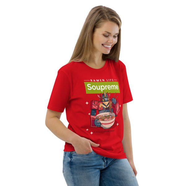 Woman smiling looking down with her body inclined to the left, right hand on her pocket. She is wearing a t-shirt featuring a japanese manga/anime styled transformers-looking robot eating a big bowl of ramen noodle soup with the logo above that reads: Soupreme; not related to any particular brand, only being there as a joke to the main subject of the design, that being ramen noodle soup
