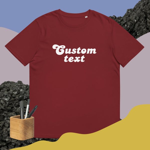 Burgundy custom shirt with a cool and dinamic background and some pencils that symbolize how this t-shirt is customizable and can be bought with your custom design printed on it.